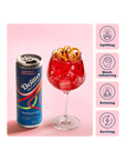 Can of Domino Zero Proof Elixir next to a red cocktail with garnish on a pink background