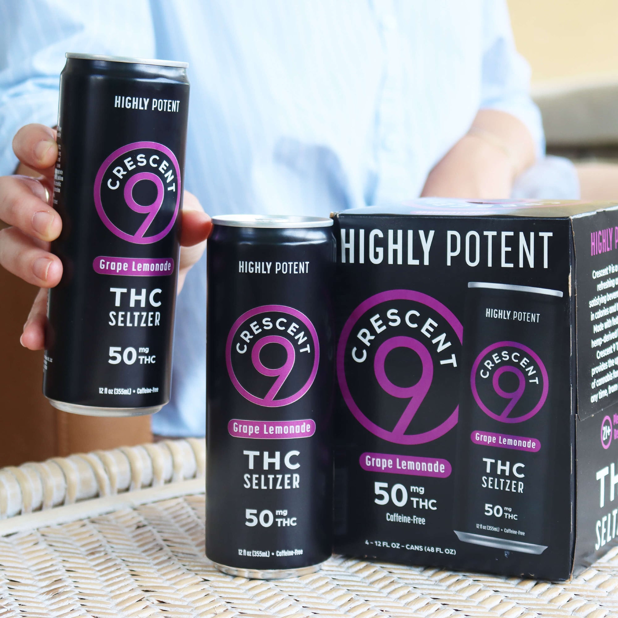 A pack of Crescent 9 Grape Lemonade THC Seltzer with one can in hand