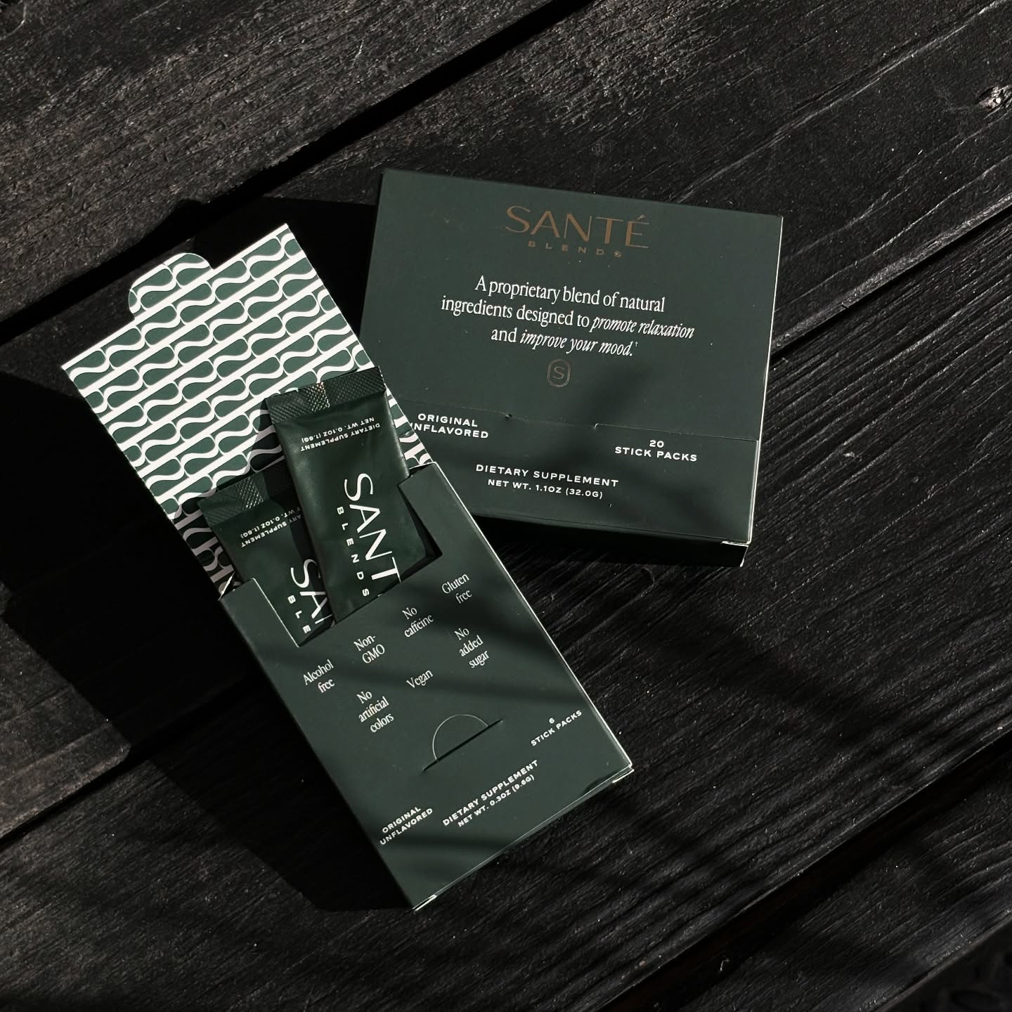 Sante dietary supplement packaging on a dark wooden surface